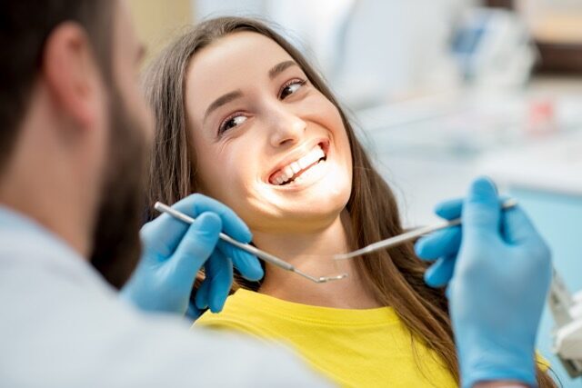 Woman smiling during a dental checkup at Bell Road Dentistry